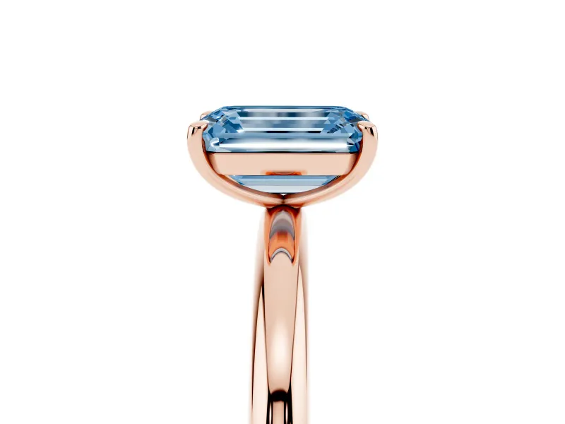 Fancy Blue Emerald Cut Diamond Solitaire Ring Set in Rose gold with Prong Setting on a Polished Plain Band