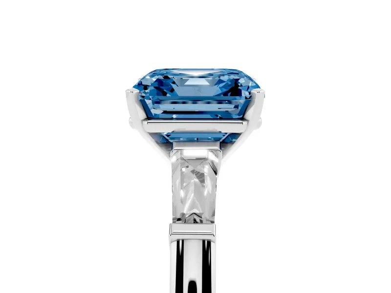 Fancy Blue Asscher Cut Diamond Solitaire Ring Set in White gold with Tapered Baguette Side Stones and Prong Setting