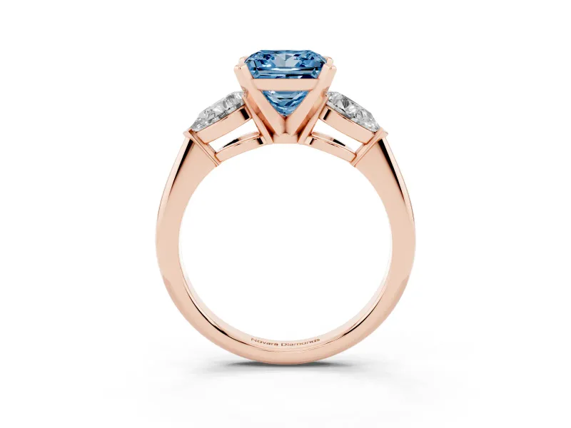 Fancy Blue Three-Stone Princess Cut Diamond Ring Set in Rose gold with Pear Side Stones and Prong Setting