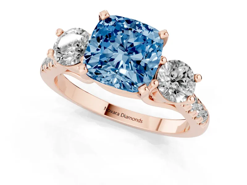 Fancy Blue Three-Stone Cushion Cut Diamond Pavé Band Ring Set in Rose gold with Prong-Set Trio