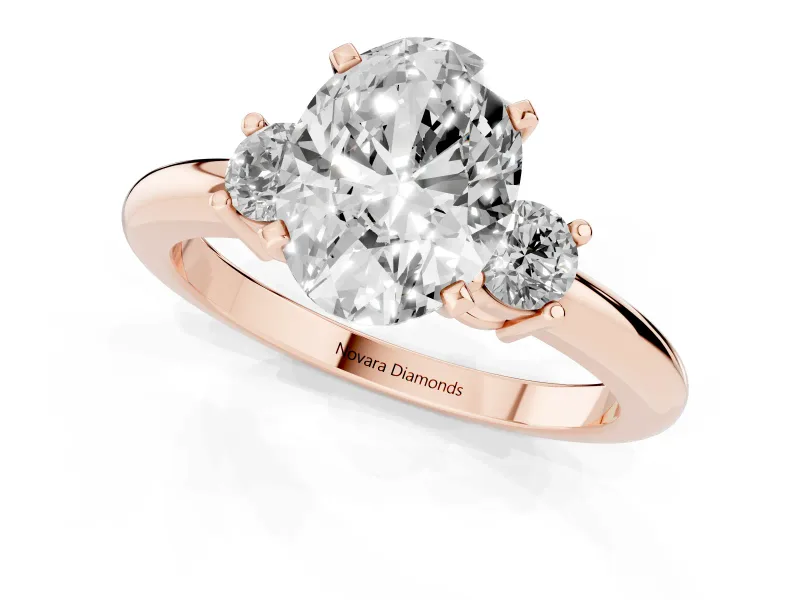 Three-Stone Oval Cut Diamond Ring Set in Rose gold with Prong Setting and Plain Band