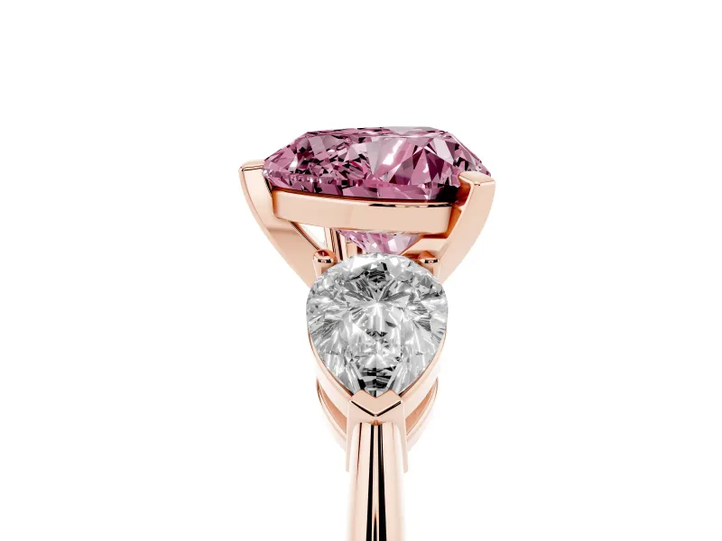 Fancy Pink Three-Stone Heart Cut Diamond Ring Set in Rose gold with Pear Side Stones and Prong Setting