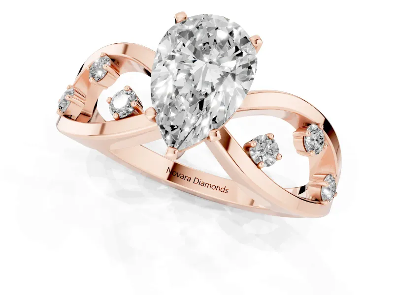 Pear Cut Diamond Solitaire Ring Set in Rose gold with Side Stones on Criss-Cross Band and Prong Setting