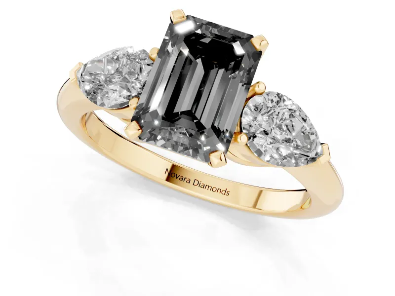 Fancy Black Three-Stone Emerald Cut Diamond Ring Set in Yellow gold with Pear Side Stones and Prong Setting