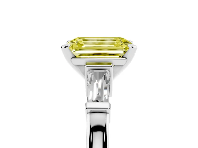 Fancy Yellow Emerald Cut Diamond Solitaire Ring Set in Platinum with Tapered Baguette Accents and Prong Setting