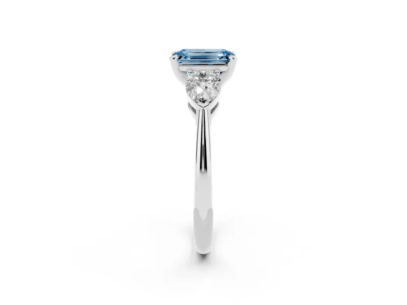 Fancy Blue Three-Stone Emerald Cut Diamond Ring Set in Platinum with Pear Side Stones and Prong Setting