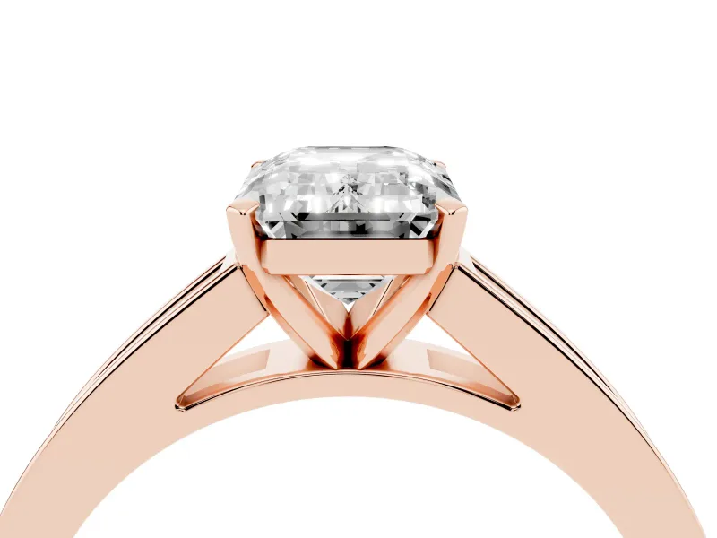 Emerald Cut Diamond Solitaire Ring Set in Rose gold with Channel-Set Band and Prong Setting