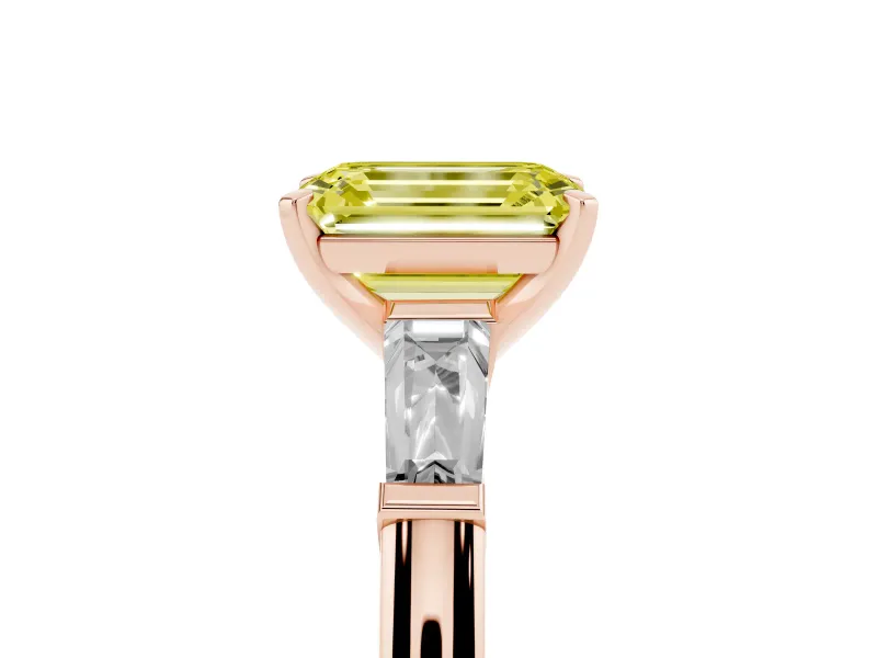 Fancy Yellow Emerald Cut Diamond Solitaire Ring Set in Rose gold with Tapered Baguette Side Stones and Prong Setting