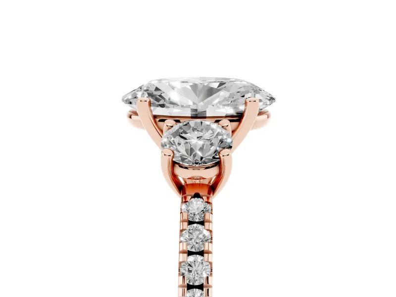 Oval Cut Diamond Three-Stone Ring Set in Rose gold with Pavé Band and Graduated Sides