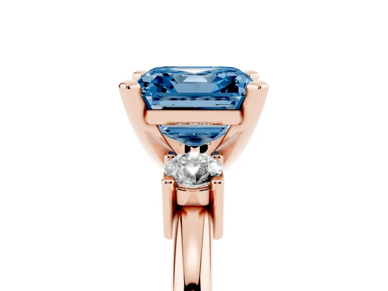 Fancy Blue Three-Stone Asscher Cut Diamond Ring Set in Rose gold with Prong Setting and Plain Band