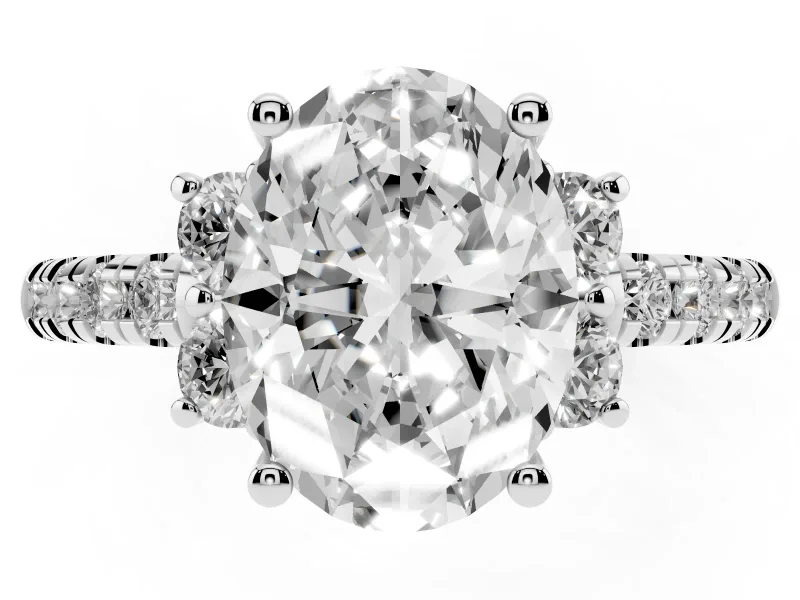 Oval Cut Diamond Three-Stone Pavé Ring Set in Platinum with Prong Setting