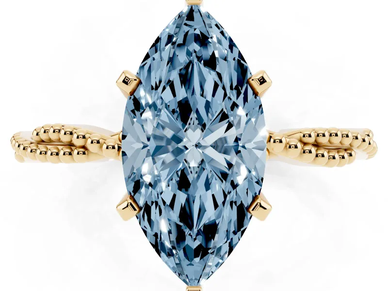 Fancy Blue Marquise Cut Diamond Solitaire Ring Set in Yellow gold with Twisted Band and Bead Prong Setting