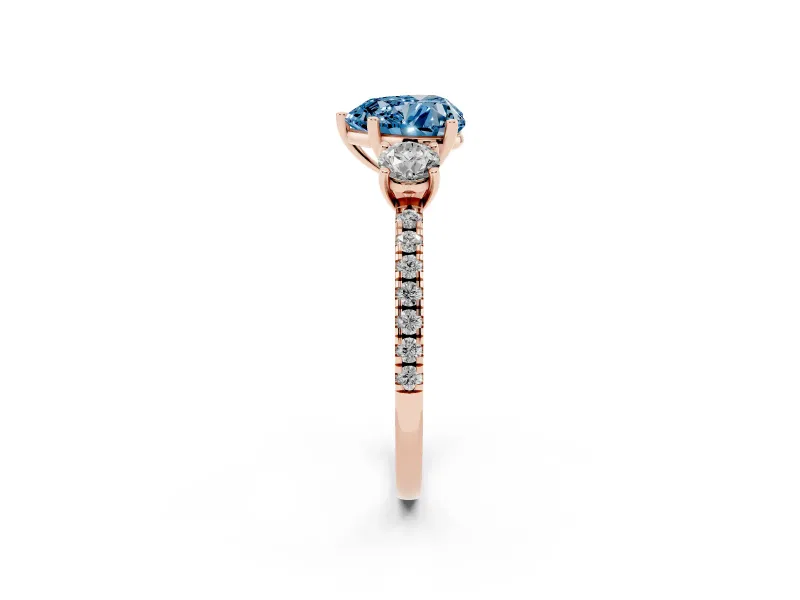 Fancy Blue Heart Cut Diamond Three-Stone Ring Set in Rose gold with Pavé Band and Graduated Sides