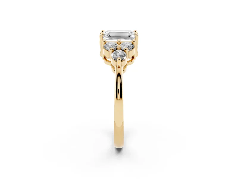 Emerald Cut Diamond Solitaire Ring Set in Yellow gold with Cluster Accents on Each Side