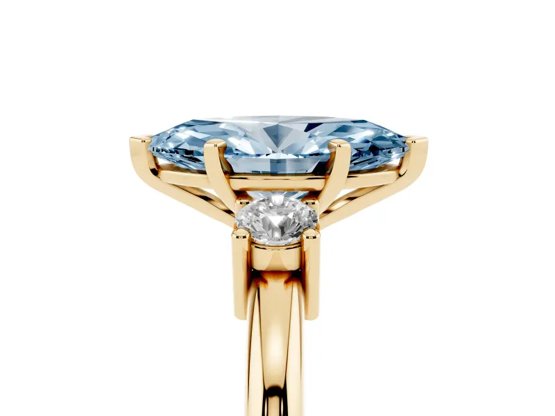 Fancy Blue Three-Stone Marquise Cut Diamond Ring Set in Yellow gold with Prong Setting and Plain Band