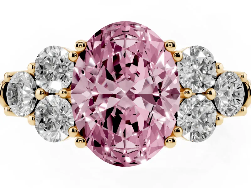 Fancy Pink Oval Cut Diamond Cluster Ring Set in Yellow gold with Round Accent Stones and Prong Setting on a Plain Band