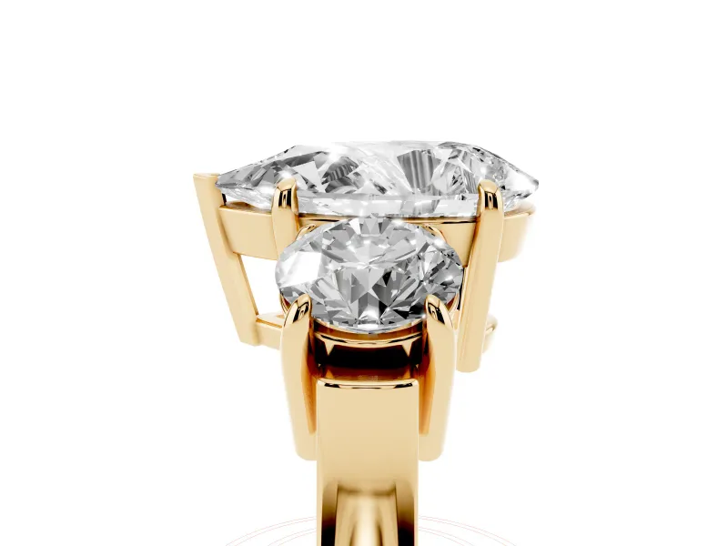 Pear Cut Diamond Three-Stone Ring Set in Yellow gold with Round Accent Stones and Plain Band