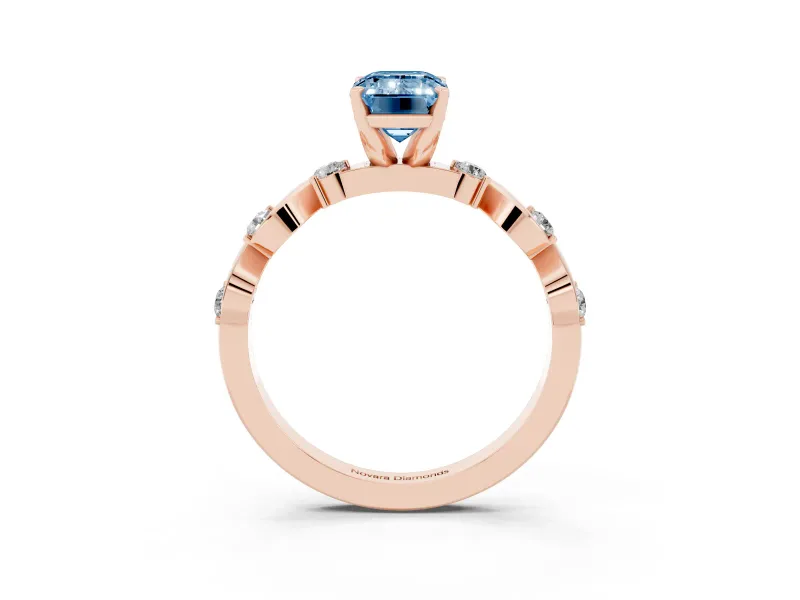 Fancy Blue Emerald Cut Diamond Solitaire Ring Set in Rose gold with Ribbon Twist Band, Round Accents and Prong Setting