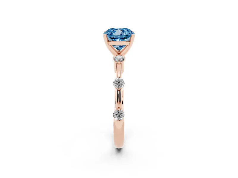 Fancy Blue Cushion Cut Diamond Solitaire Ring Set in Rose gold with Bezel Set Side Stones and Prong Setting