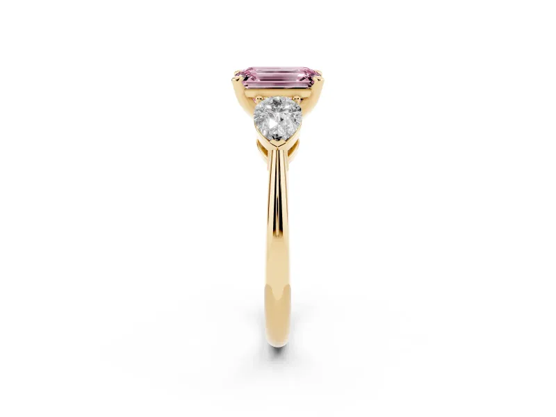 Fancy Pink Three-Stone Emerald Cut Diamond Ring Set in Yellow gold with Pear Side Stones and Prong Setting