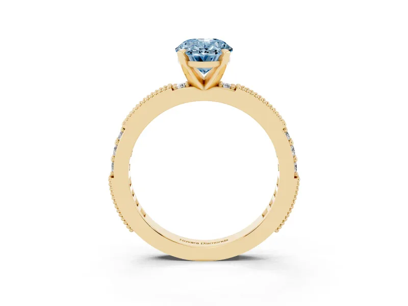 Fancy Blue Oval Cut Diamond Solitaire Ring Set in Yellow gold with Slim Pavé Band and Prong Setting