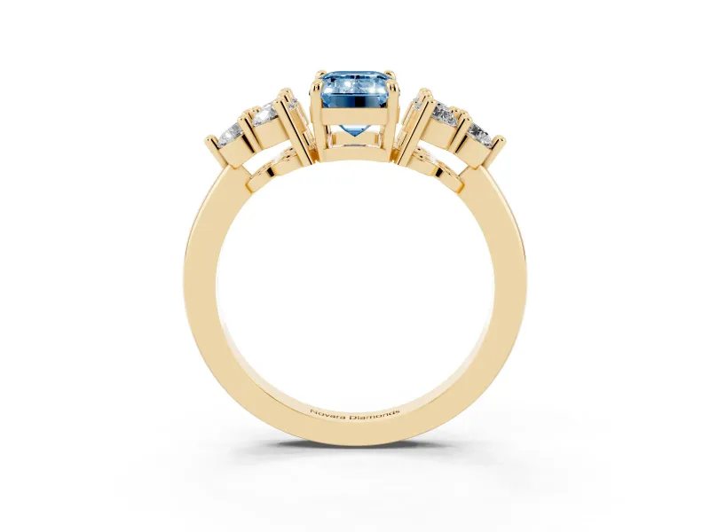 Fancy Blue Emerald Cut Diamond Solitaire Ring Set in Yellow gold with Cluster Accents on Each Side