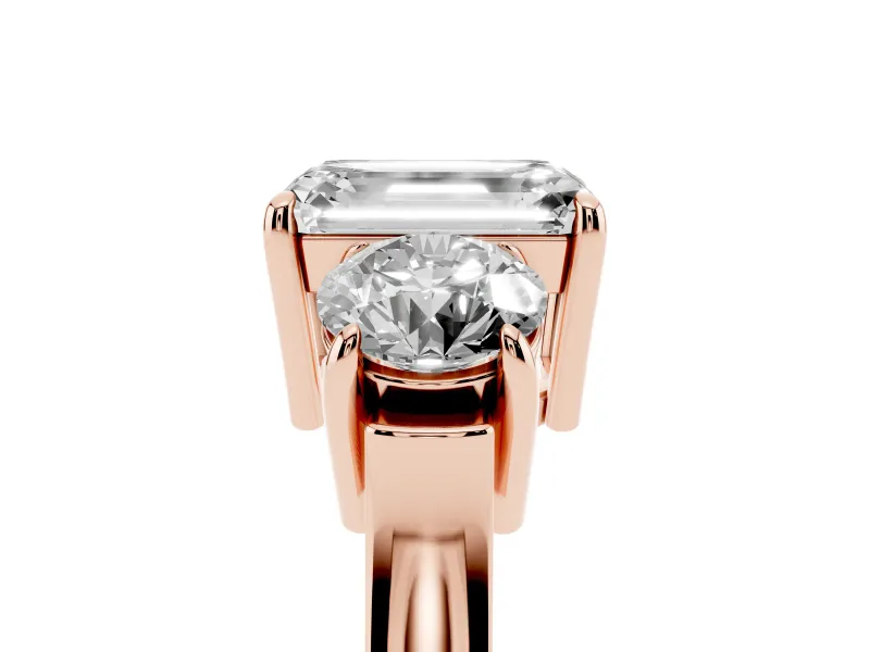 Emerald Cut Three Stone Engagement Ring Setting | Round Side Stones and Open Baskets | Rose Gold