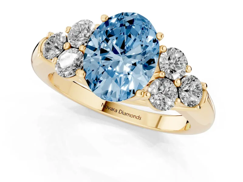 Fancy Blue Oval Cut Diamond Cluster Ring Set in Yellow gold with Round Accent Stones and Prong Setting on a Plain Band