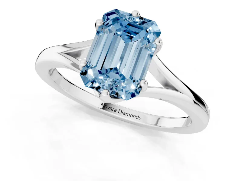 Fancy Blue Emerald Cut Diamond Solitaire Ring Set in White gold with Polished Tapered Band and Prong Setting