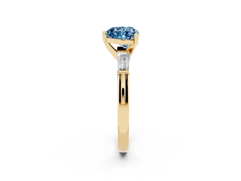 Fancy Blue Heart Cut Diamond Solitaire Ring Set in Yellow gold with Tapered Baguette Side Stones and Prong Setting