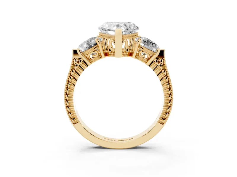 Heart Cut Diamond Three-Stone Ring Set in Yellow gold with Milgrain Band