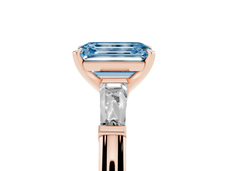 Fancy Blue Emerald Cut Diamond Solitaire Ring Set in Rose gold with Tapered Baguette Side Stones and Prong Setting