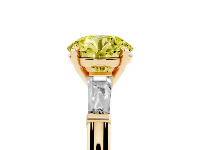 Fancy Yellow Round Cut Diamond Solitaire Ring Set in Yellow gold with Tapered Baguette Side Stones and Prong Setting