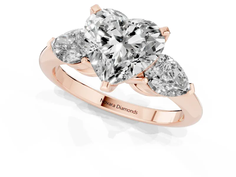 Three-Stone Heart Cut Diamond Ring Set in Rose gold with Pear Side Stones and Prong Setting