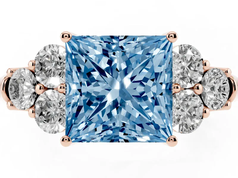 Fancy Blue Princess Cut Diamond Cluster Ring Set in Rose gold with Round Accent Stones and Prong Setting on a Plain Band