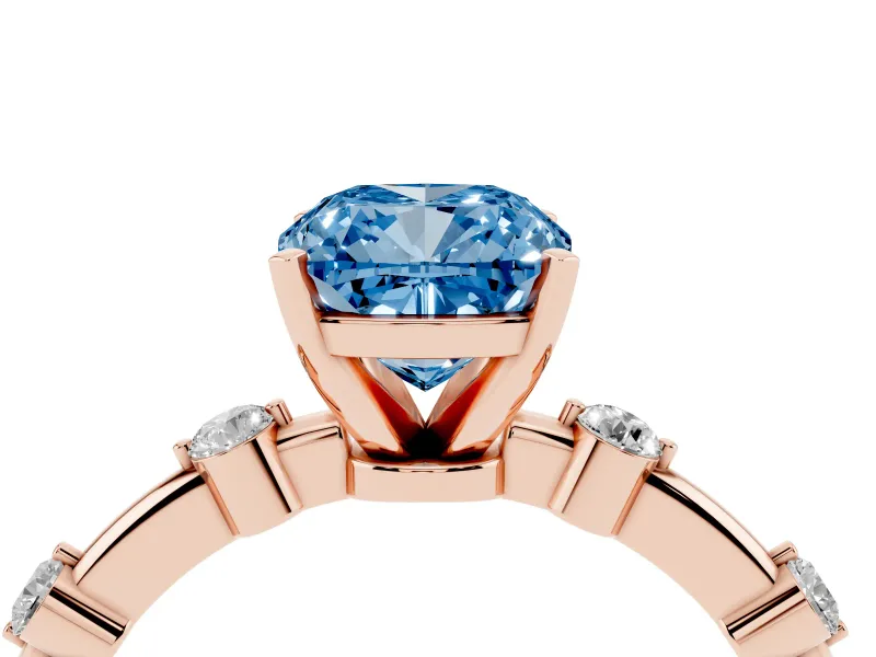 Fancy Blue Cushion Cut Diamond Solitaire Ring Set in Rose gold with Bezel Set Side Stones and Prong Setting