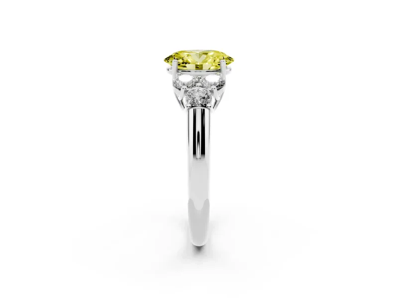 Fancy Yellow Oval Cut Diamond Cluster Ring Set in White gold with Round Accent Stones and Prong Setting on a Plain Band