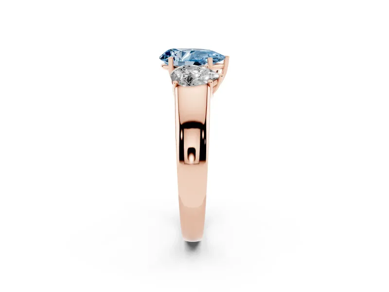 Fancy Blue Three-Stone Pear Cut Diamond Ring Set in Rose gold with Matching Prong Settings and Plain Band