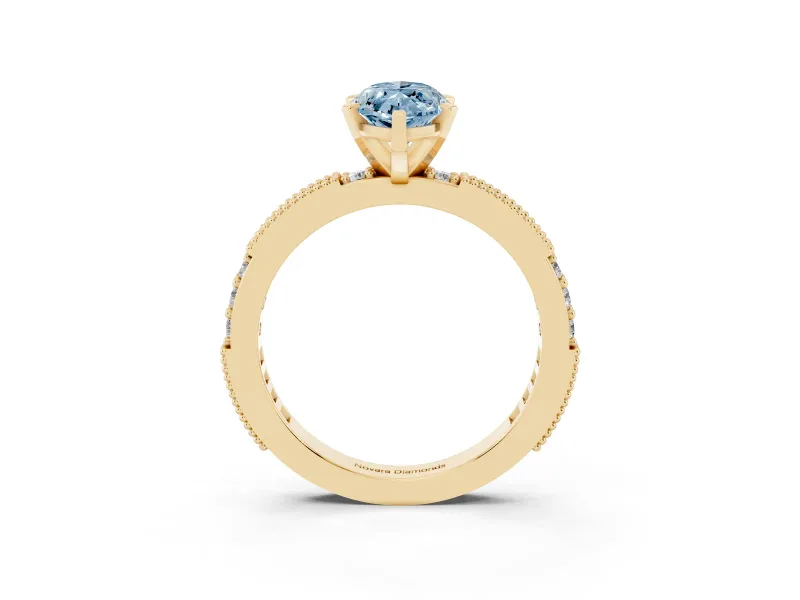 Fancy Blue Marquise Cut Diamond Solitaire Ring Set in Yellow gold with Slim Pavé Band and Prong Setting