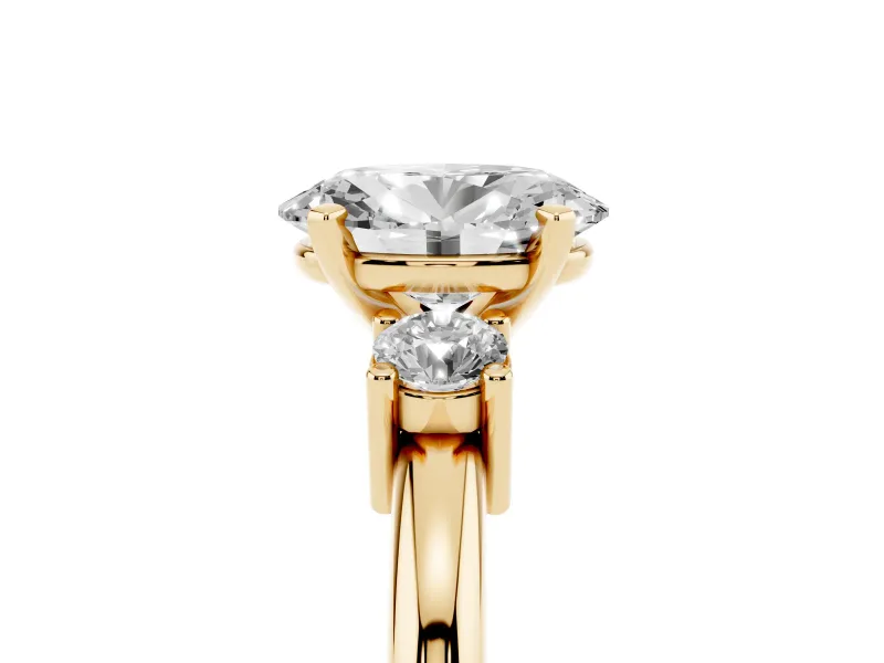 Three-Stone Oval Cut Diamond Ring Set in Yellow gold with Prong Setting and Plain Band