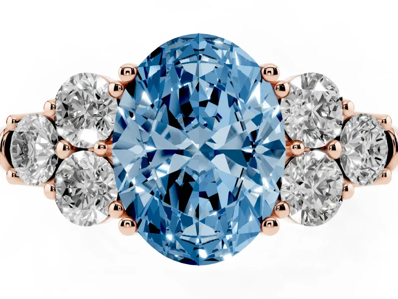 Fancy Blue Oval Cut Diamond Cluster Ring Set in Rose gold with Round Accent Stones and Prong Setting on a Plain Band