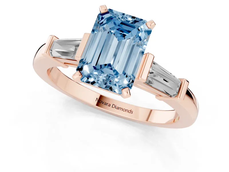 Fancy Blue Emerald Cut Diamond Solitaire Ring Set in Rose gold with Tapered Baguette Accents and Prong Setting
