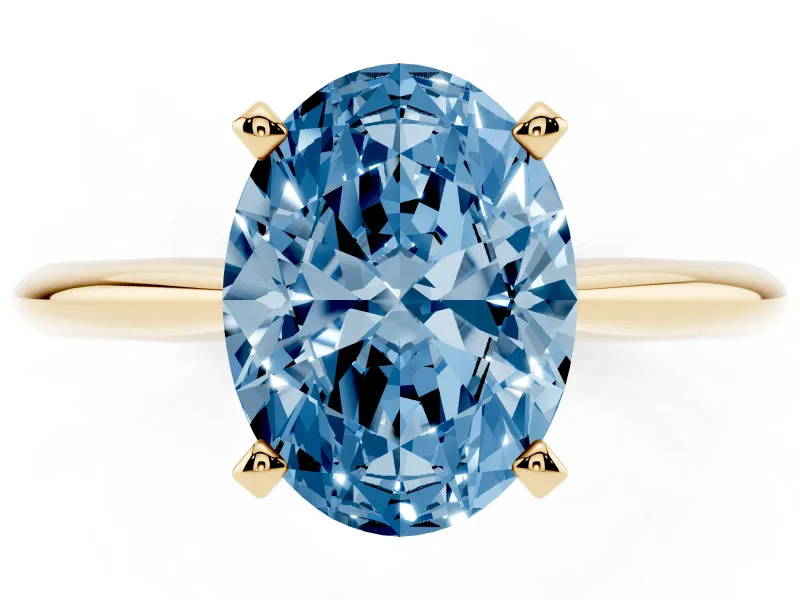Fancy Blue Oval Cut Diamond Solitaire Ring Set in Yellow gold with Prong Setting on a Plain Round Band