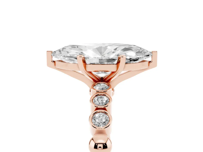 Marquise Cut Diamond Solitaire Engagement Ring Set in Rose gold with Bezel Accents on Beaded Band