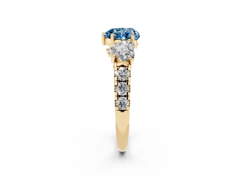 Fancy Blue Heart Cut Diamond Three-Stone Ring Set in Yellow gold with Pavé Band