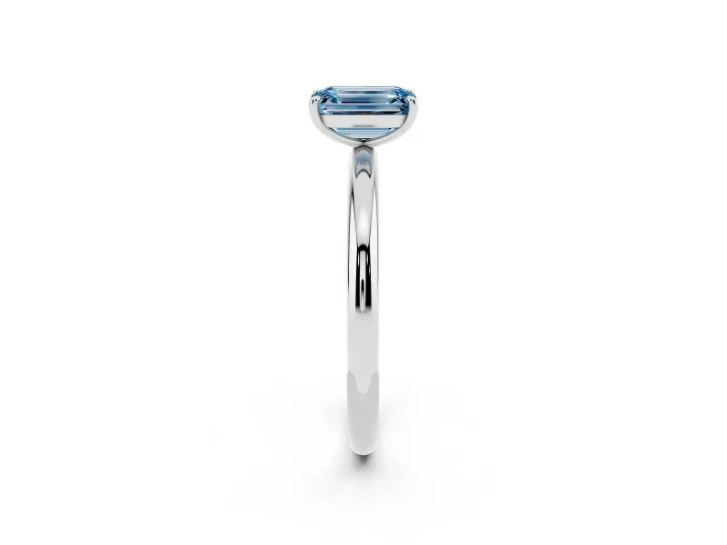 Fancy Blue Emerald Cut Diamond Solitaire Ring Set in White gold with Prong Setting on a Polished Plain Band