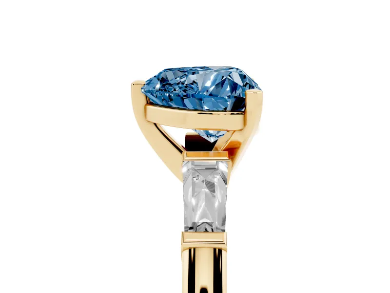Fancy Blue Heart Cut Diamond Solitaire Ring Set in Yellow gold with Tapered Baguette Side Stones and Prong Setting