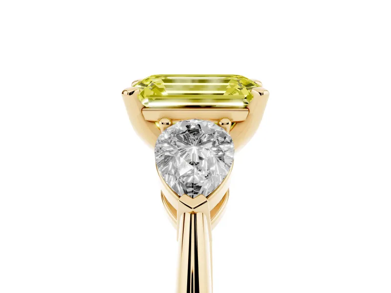 Fancy Yellow Three-Stone Emerald Cut Diamond Ring Set in Yellow gold with Pear Side Stones and Prong Setting